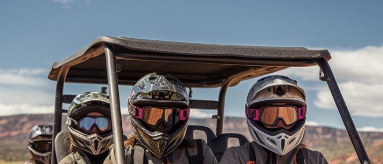 a group of 4-seater UTV riders wearing protective gear while riding through an off-road setting
