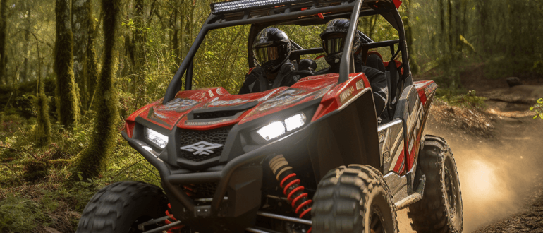 A photograph of a red 4-seater ATV driving down a dirt trail in a lush forest.