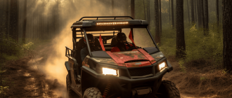 An advertisement photograph of a red 2023 model 4-seat side-by-side utility terrain vehicle driving down a dirt trail in a pine forest.